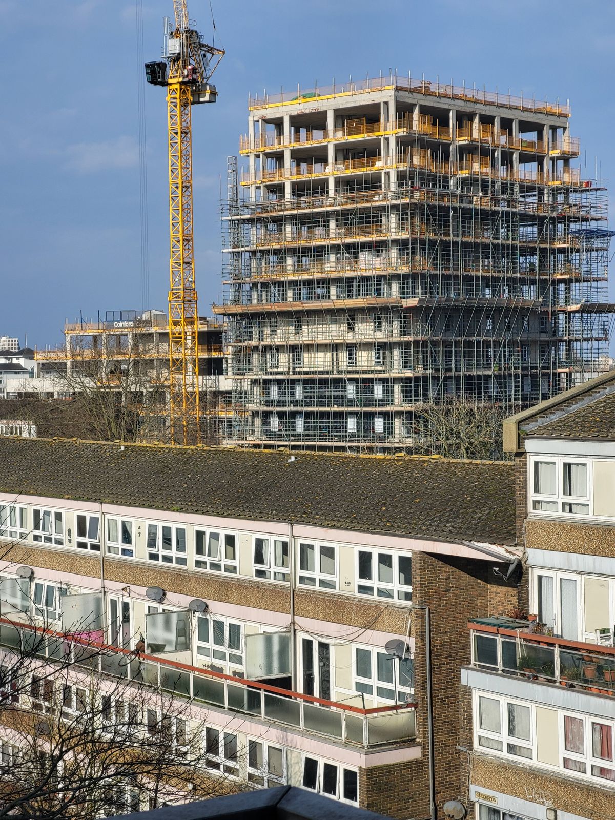 High-rise building under construction with crane
