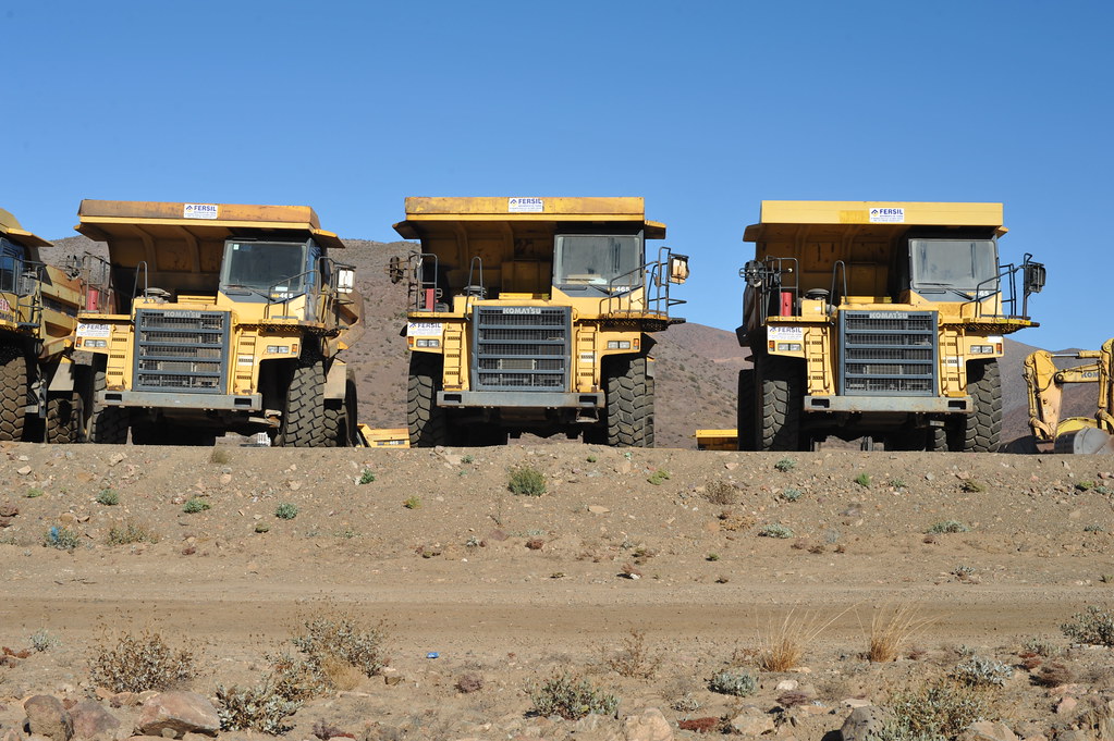 Dump trucks lined up on a site