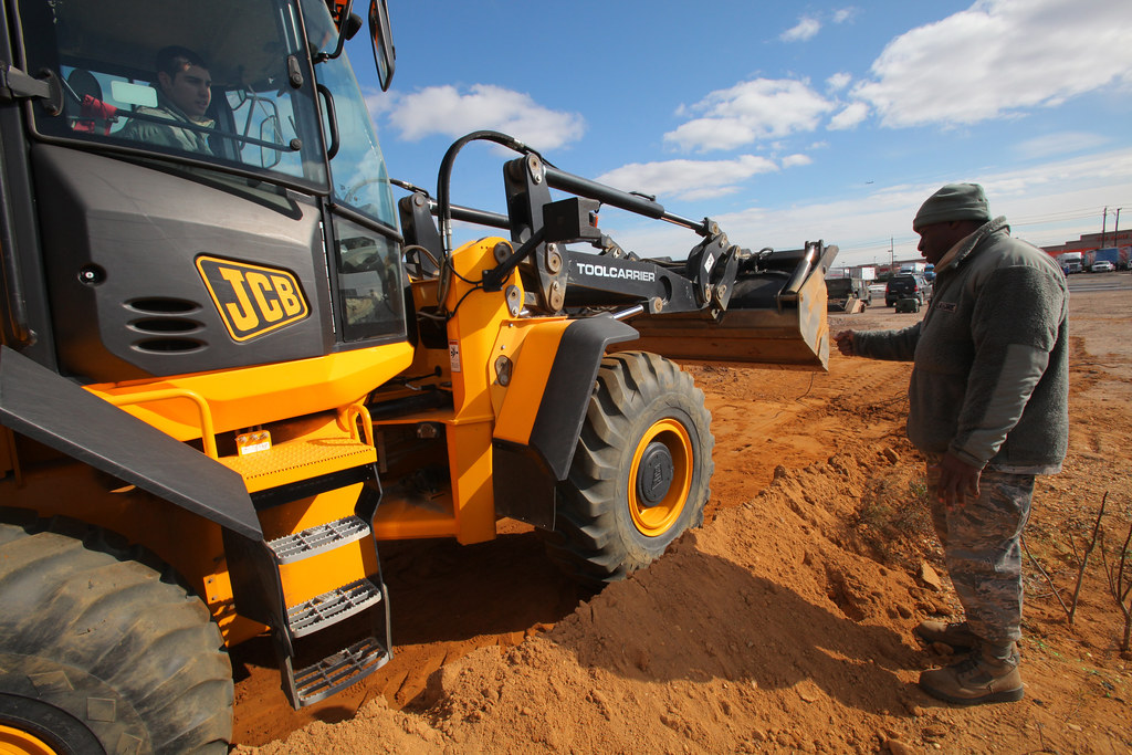Wheel loader moving material on a work site