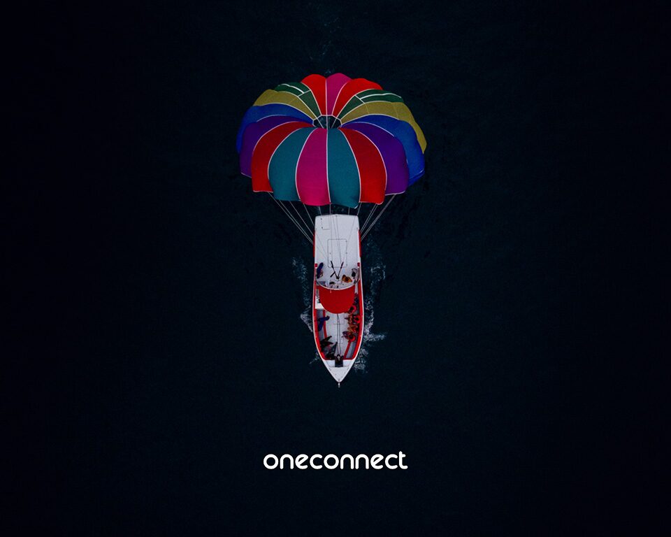 Aerial view of our crewed parasailing vessel underway with a colourful parasail
